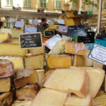 View of a cheese market stall in Aix en Provence featuring very appetising cheeses from France
