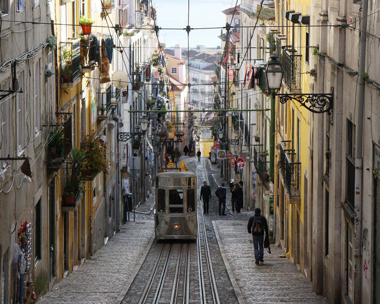 Tram on a narrow steep street in Lisbon